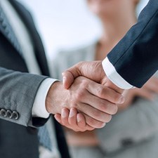 a close-up of two people shaking hands