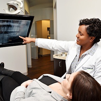 Allen dentist and patient looking at dental x-rays