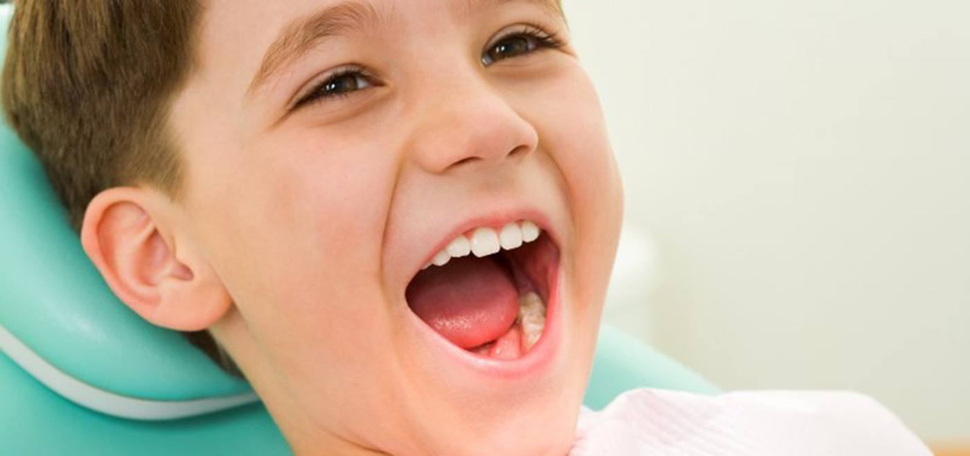 Young boy smiles after getting children’s dental sealants in Allen