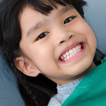 Child smiling after receiving tooth-colored filling