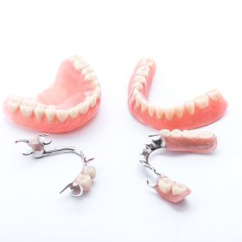 full and partial dentures against white background