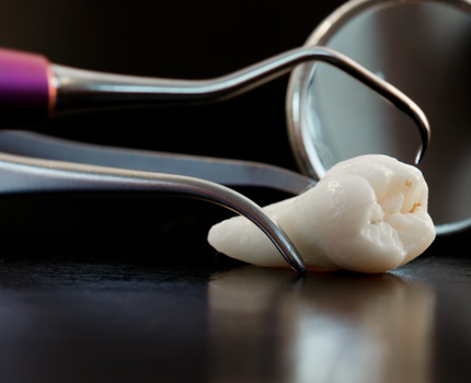 Woman having tooth extracted