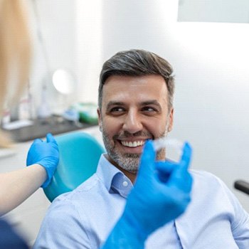 a patient smiling at his Invisalign dentist