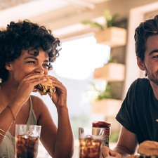 a group of friends enjoying meals and sodas