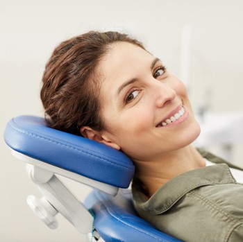 Woman in dental chair before diagnosis of periodontal disease