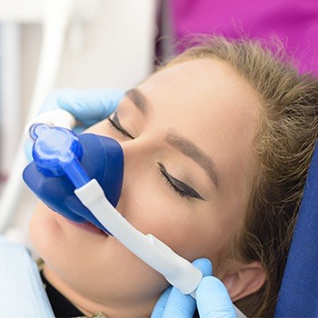 Relaxed dental patient with nitrous oxide sedation dentistry mask